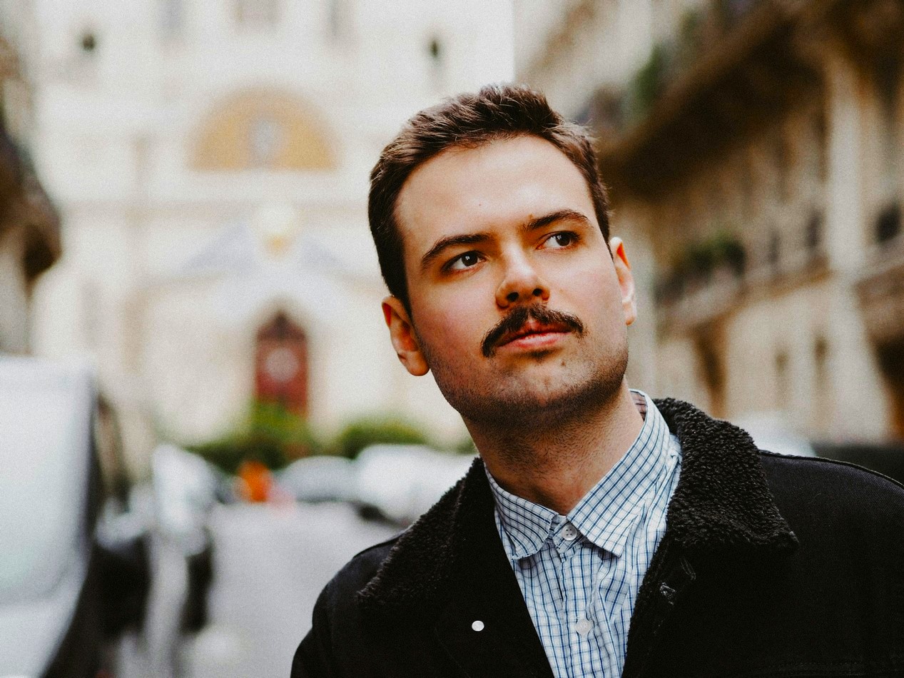 Jeune homme dans la rue avec une moustache vintage qui revient à la mode