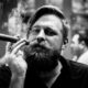 Jeune homme fumant le cigare et arborant une belle moustache vintage